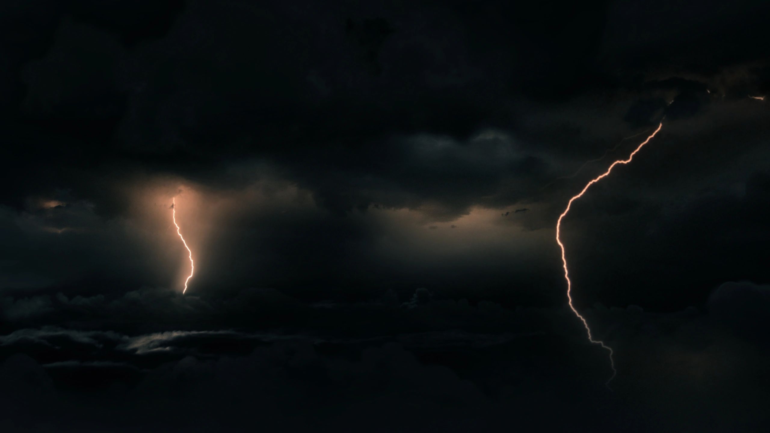 Dark storm clouds with lightning over tropical cyclone system