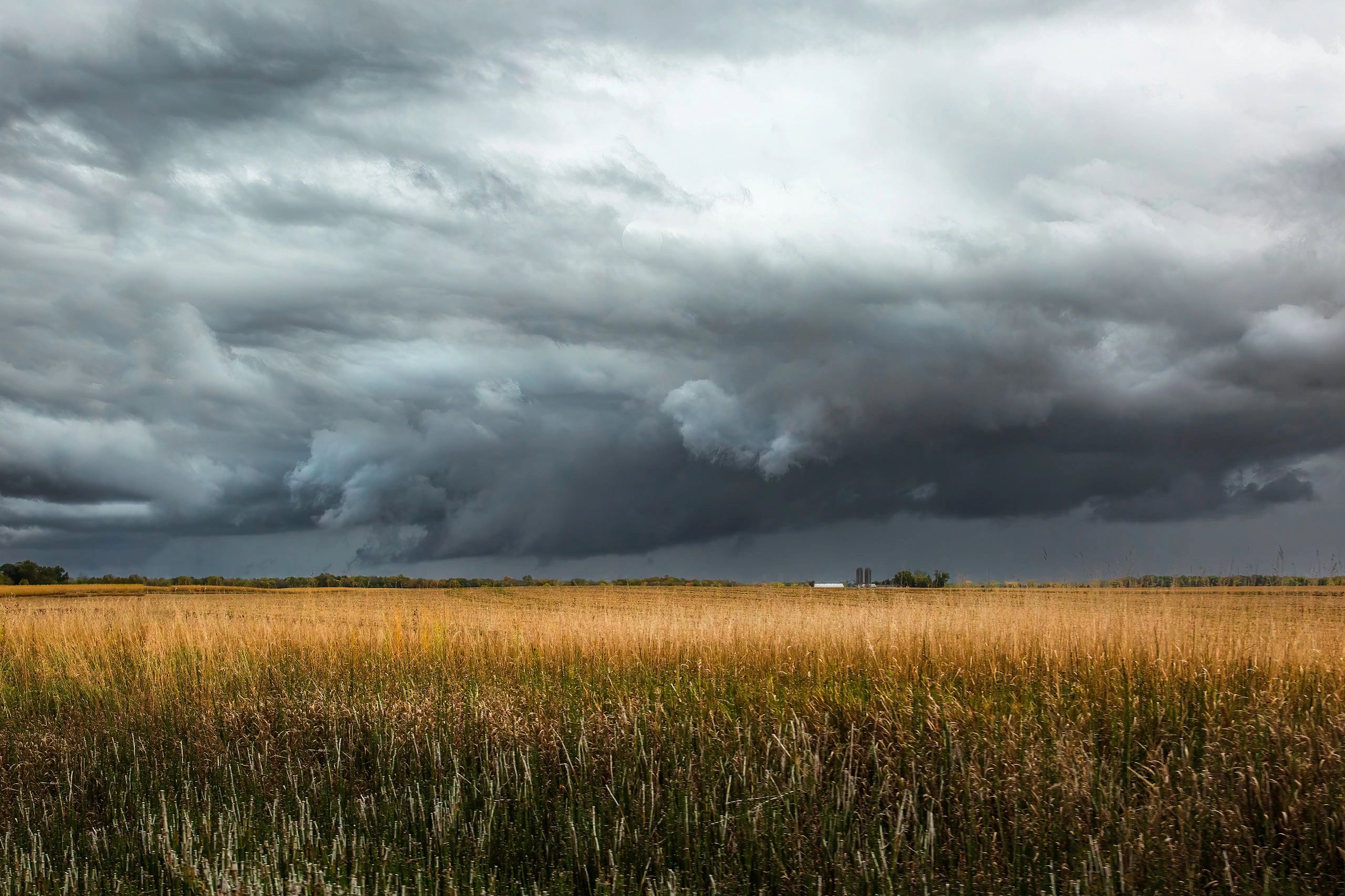 Dramatic storm clouds over open field