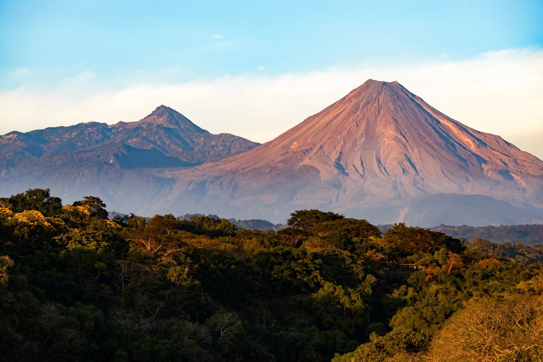 Distant volcanoes under a dramatic sky