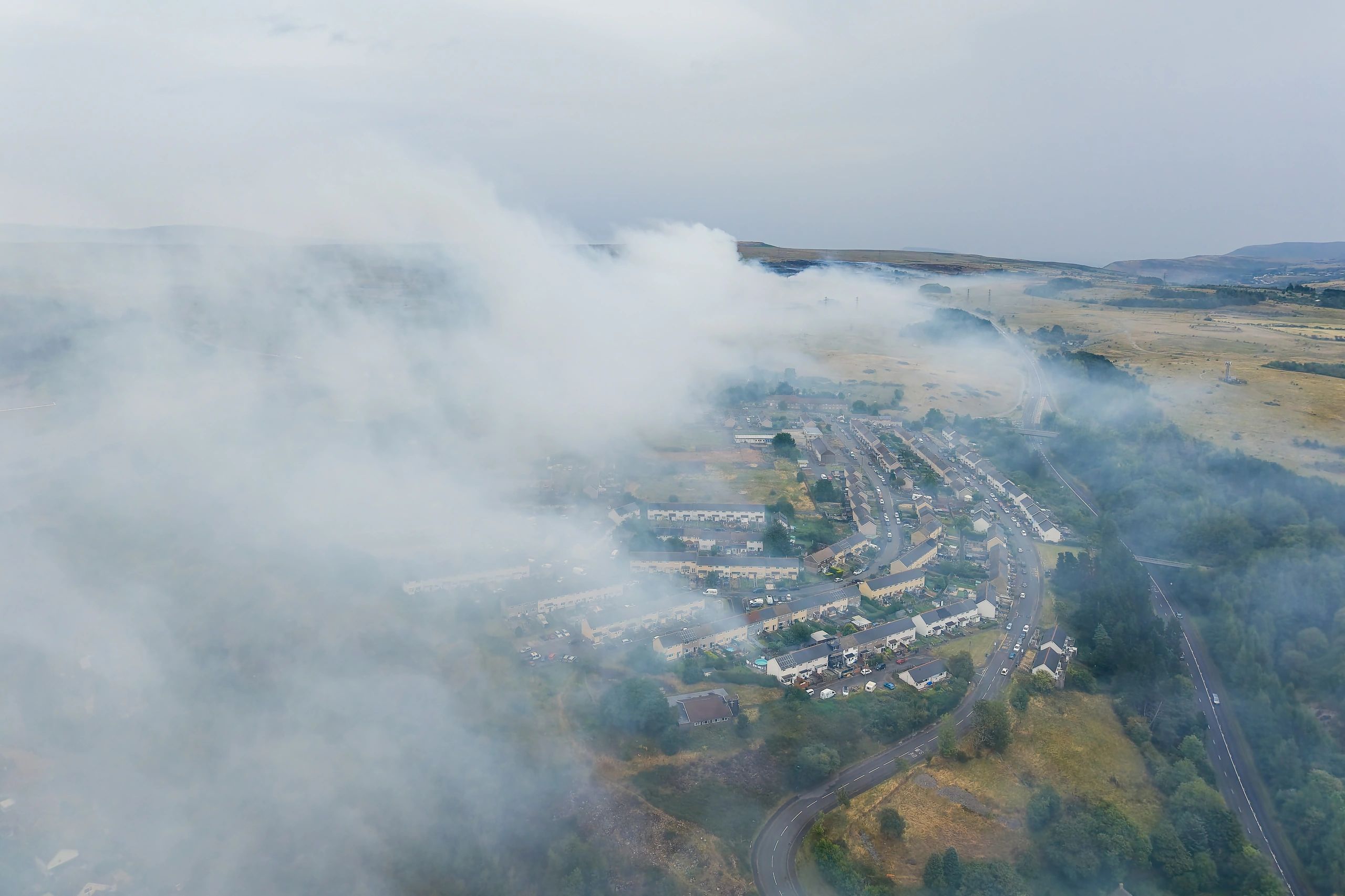 Wildfire smoke plume drifting over a town