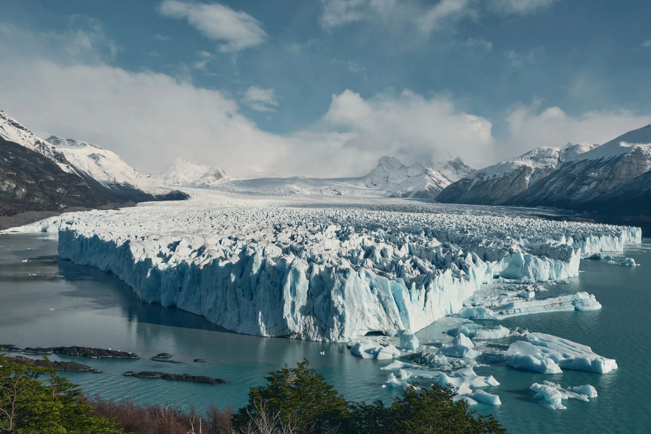 Glacier ice wall meeting a glacial lake