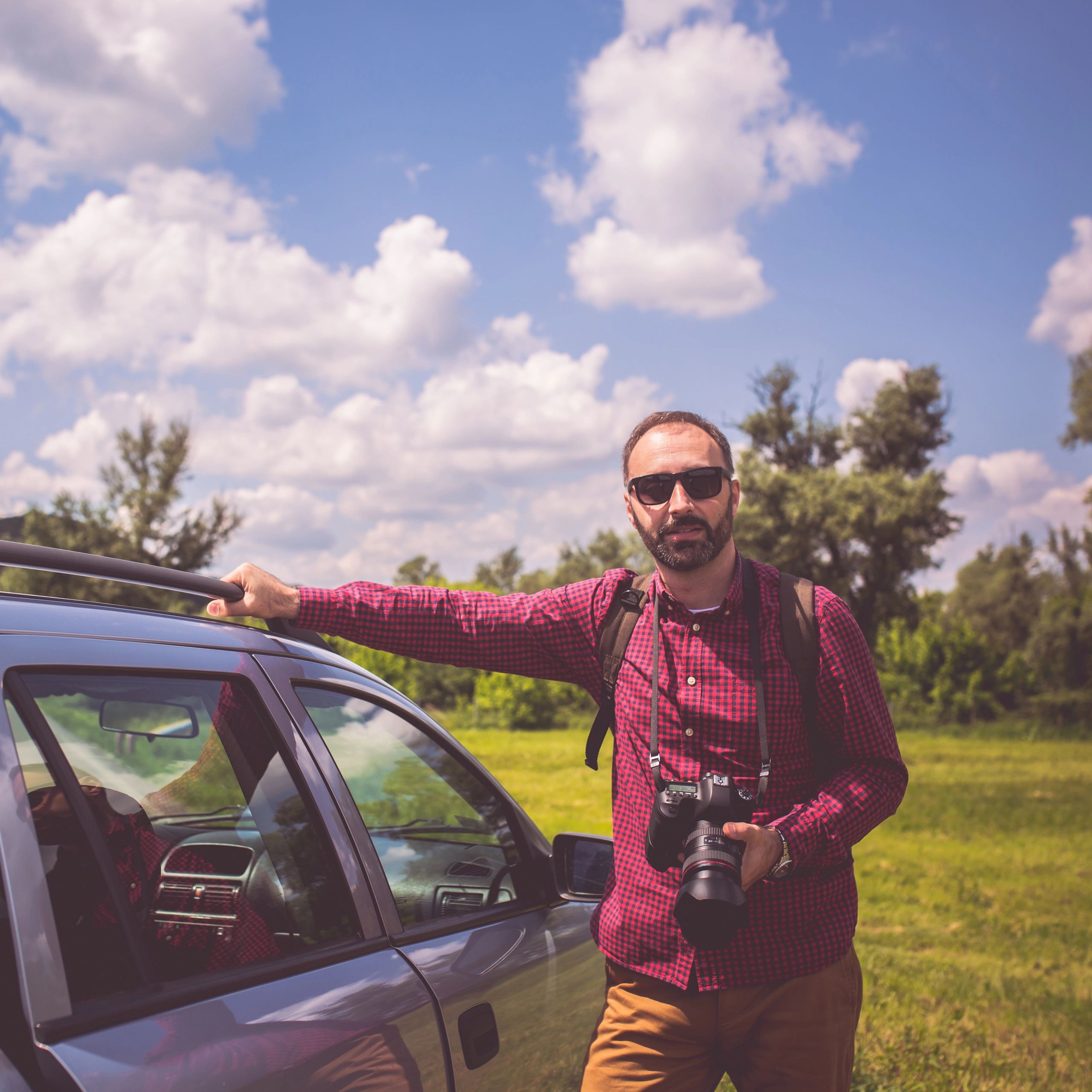 Photographer working outdoors with camera in hand